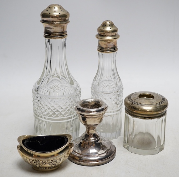 A modern pair of silver mounted glass match strikes, a pair of silver dwarf candlesticks and sundry silver including condiments and cruet bottles. Condition - poor to fair